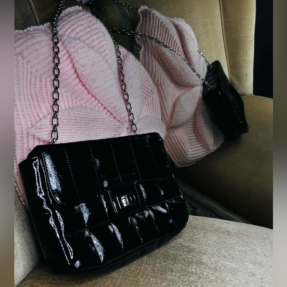 Black faux leather quilted rectangle purse with silver chain, and twist closure